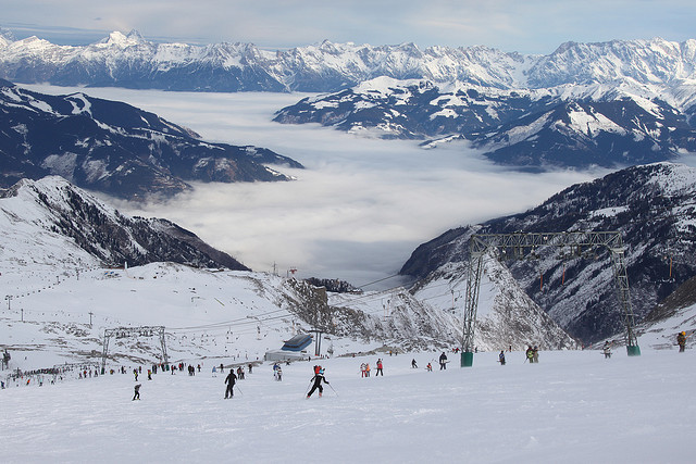 Image of skiers in an alpine ski resort on a snowy day