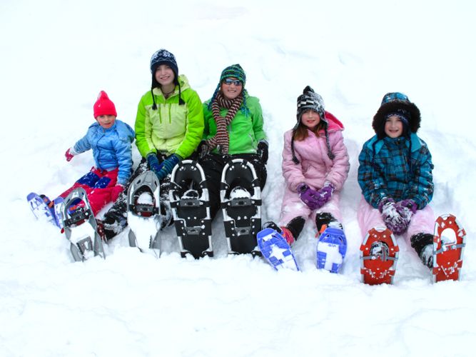 People sitting down in snowshoes