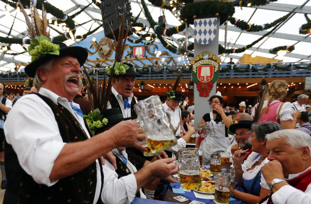 Revellers salute with beer after the opening of the 179th Oktoberfest in Munich