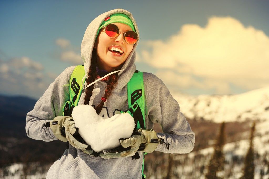 Winter sport, snowboarding - portrait of young snowboarder girl