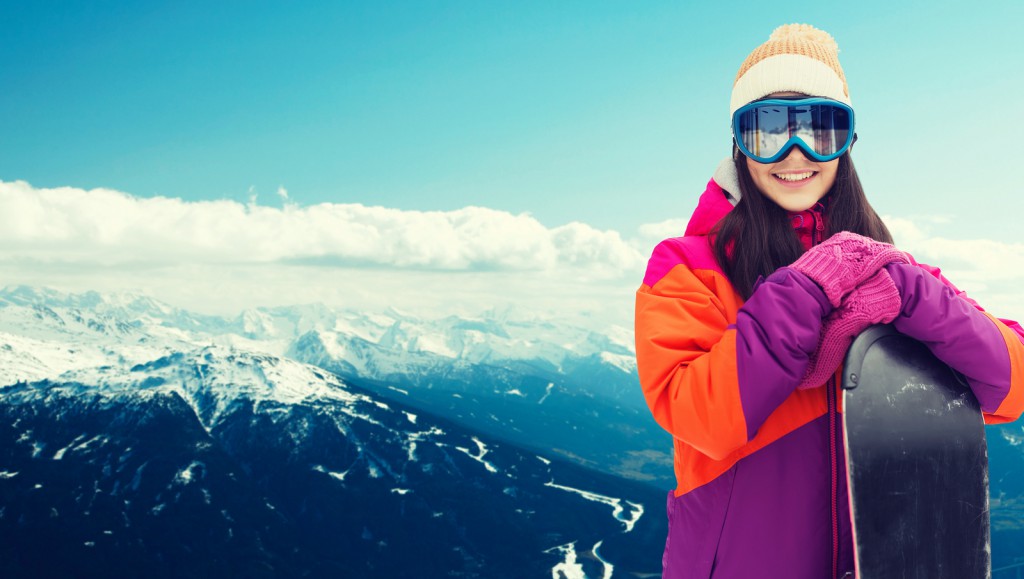 winter, leisure, sport and people concept - happy young woman in