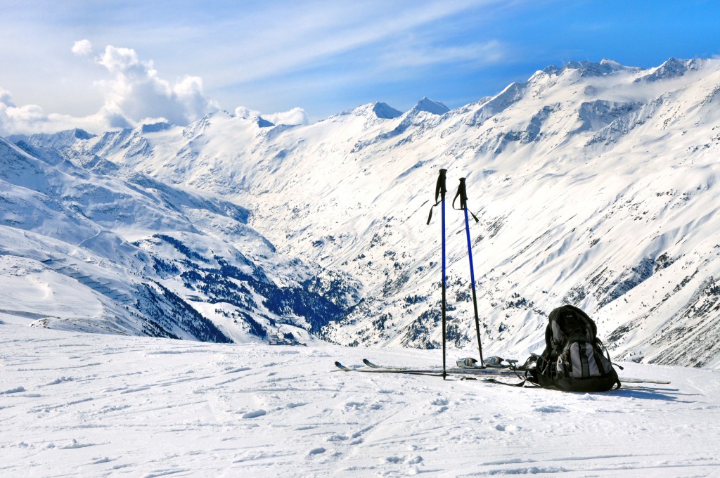 Skis, Ski Poles And Backpack In Alps