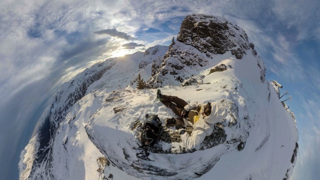 Skier relaxing at a mountain's peak