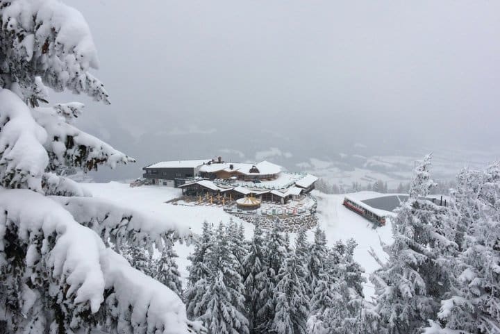 An Austrian chalet surrounded by snow and trees