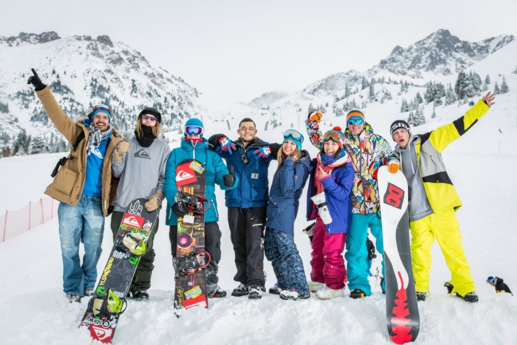 group ski holiday - friends on the mountain with snowboards
