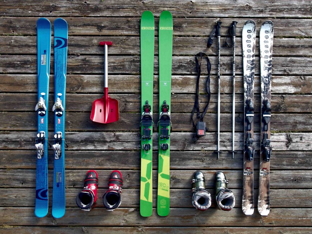 Skis, ski poles and ski boots on floor