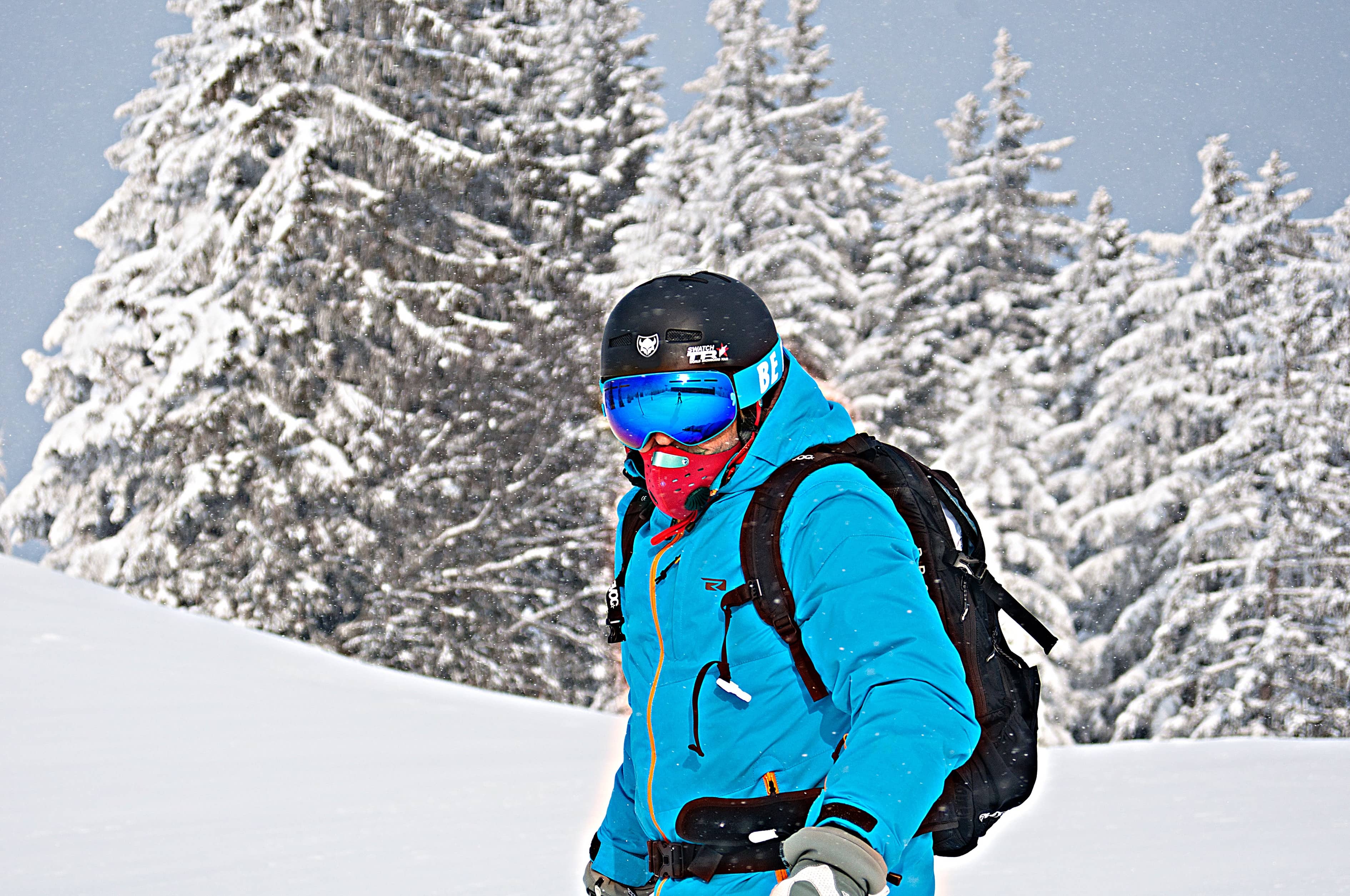 Skier dressed in blue ski gear on mountain
