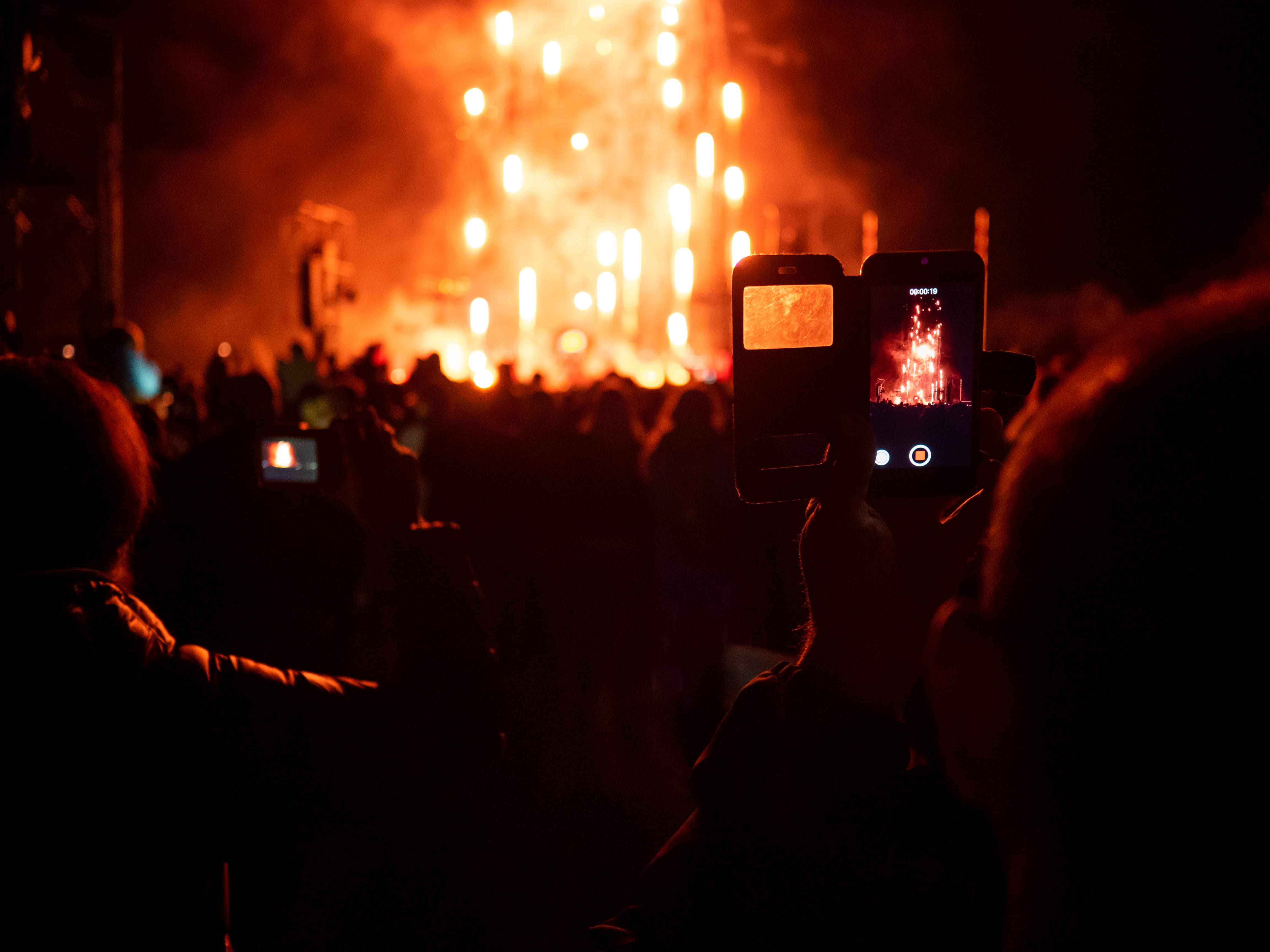 Crowd of people watching fireworks on stage at a ski music festival