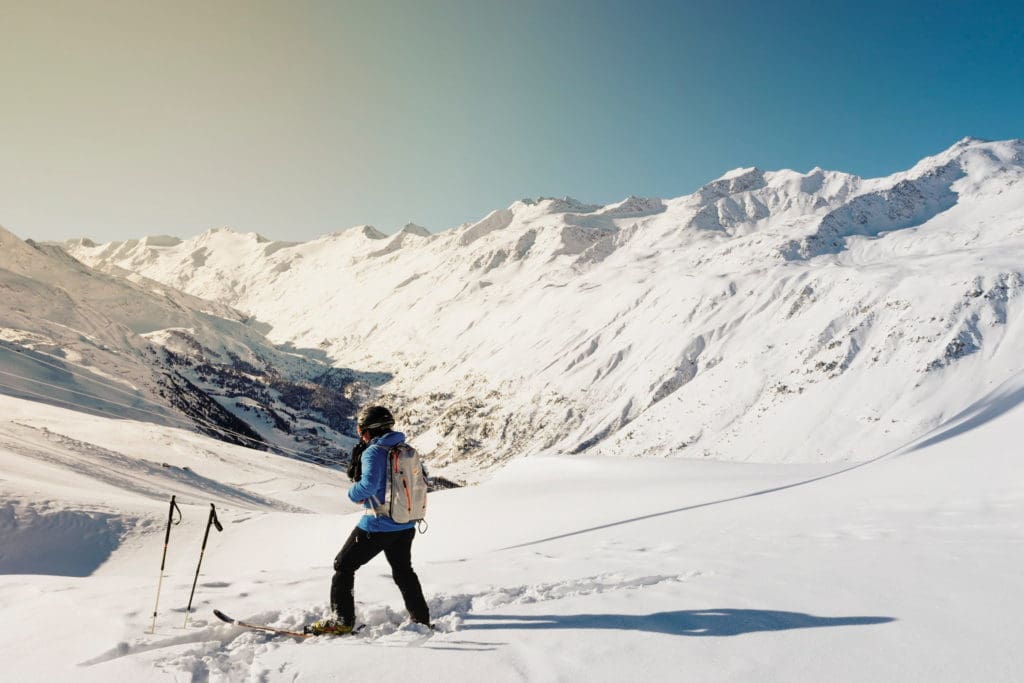 Skier surrounded by mountain slopes