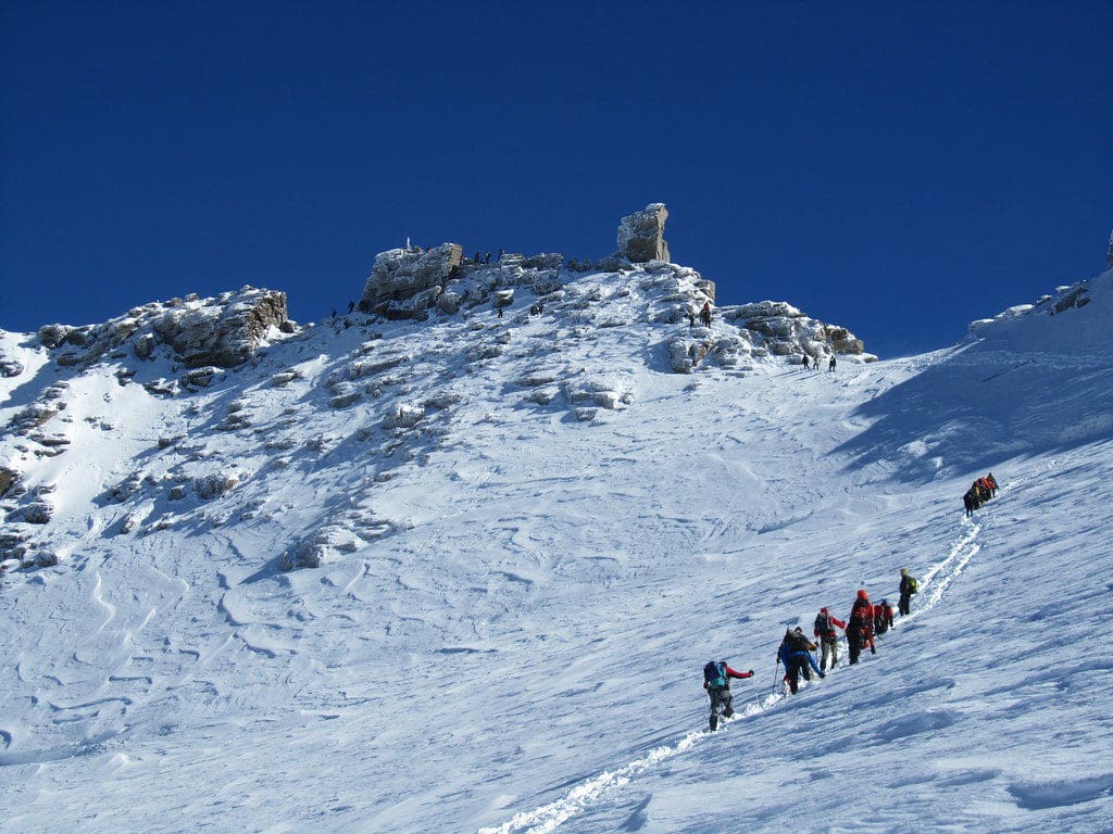 Hikers on a snowy mountain attempting the grand paradiso climb