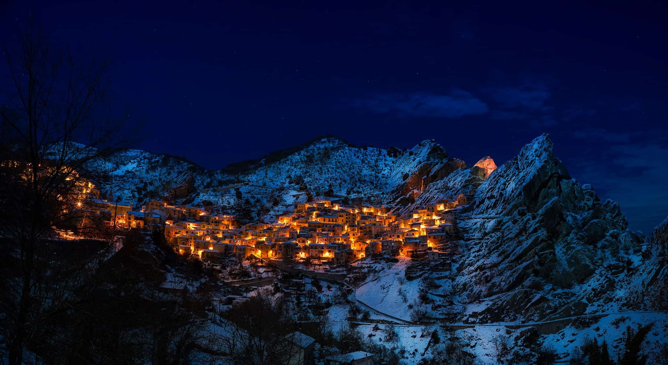 Snowy Alpine ski resort lit up on a Christmas night 