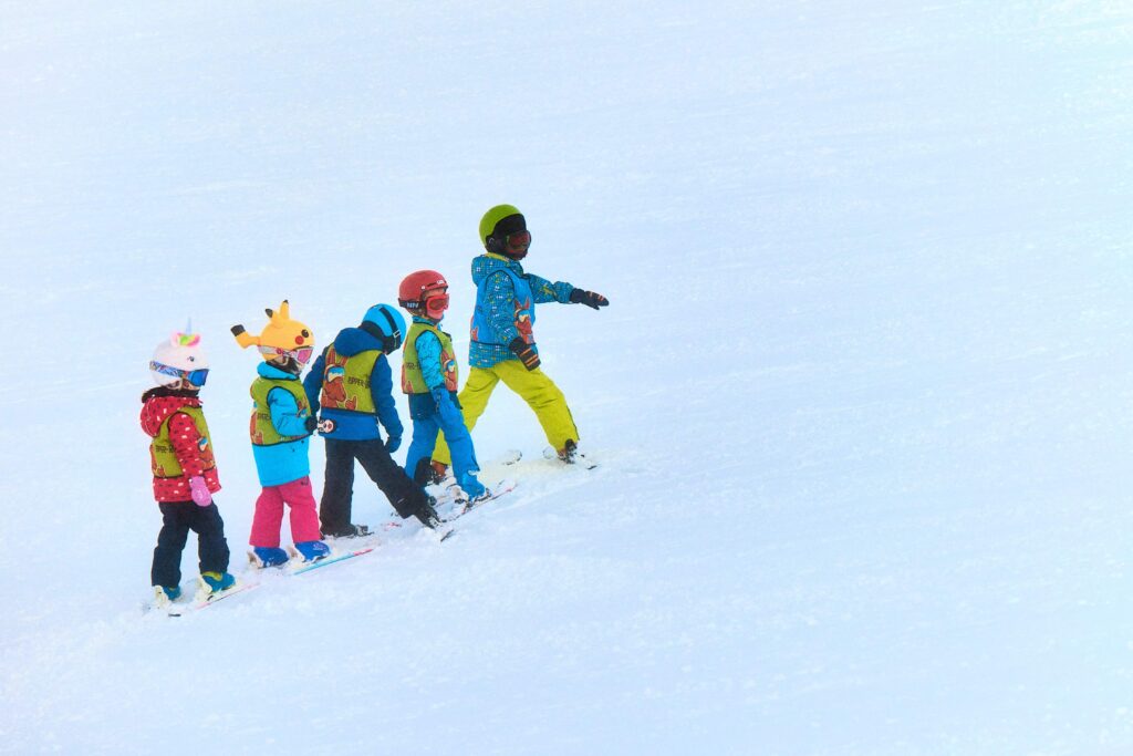 Children skiing in a line