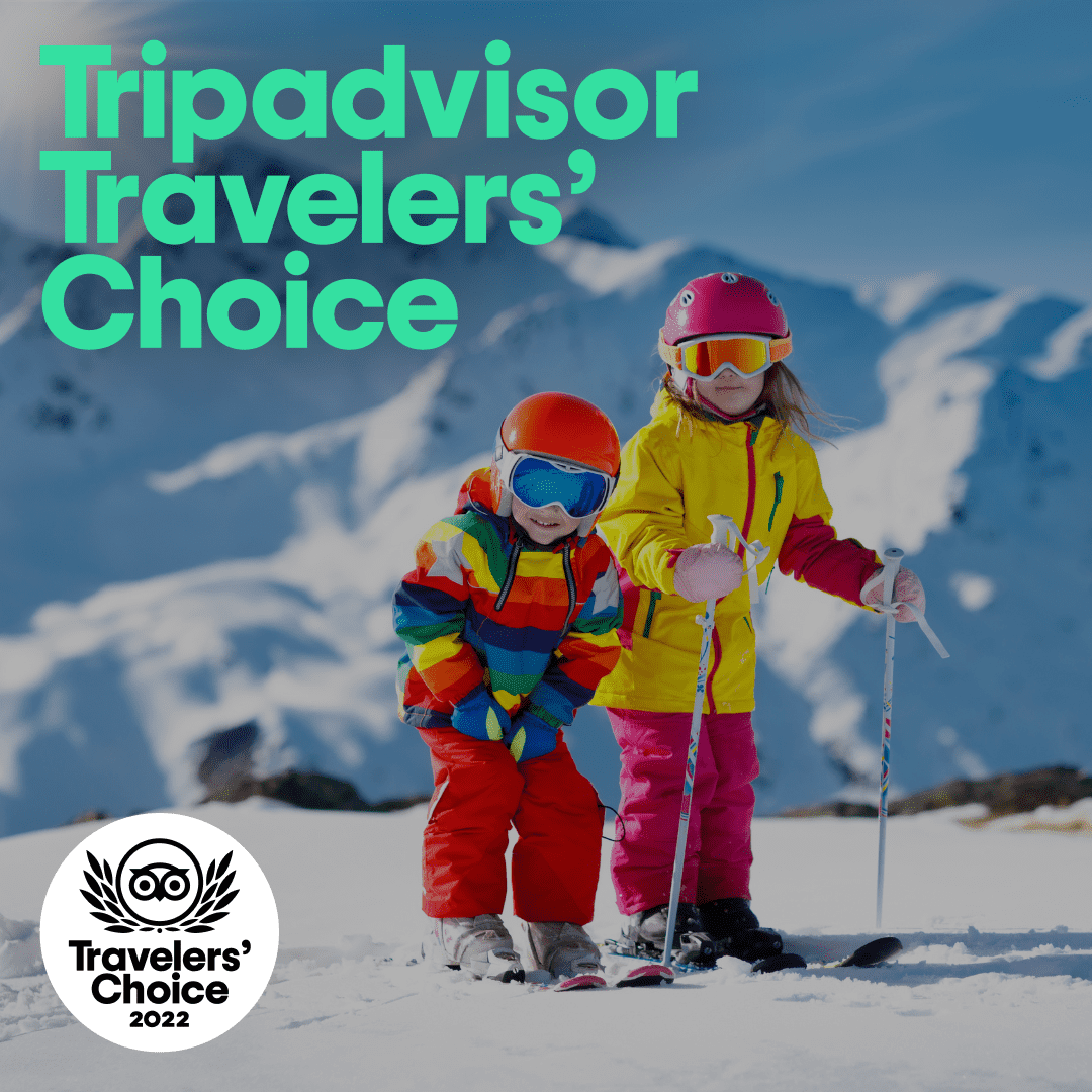 Two children in ski wear in the snow with Tripadvisor Traveler's Choice award logo