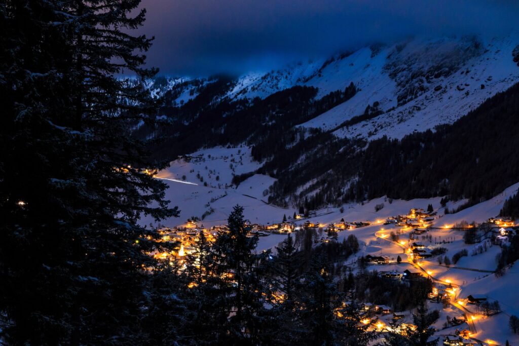 Birds eye view of a snowy Alpine village at night