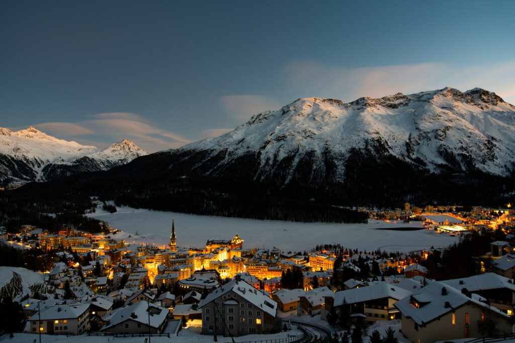 Houses in Engadin, St Moritz, lit up at night time 