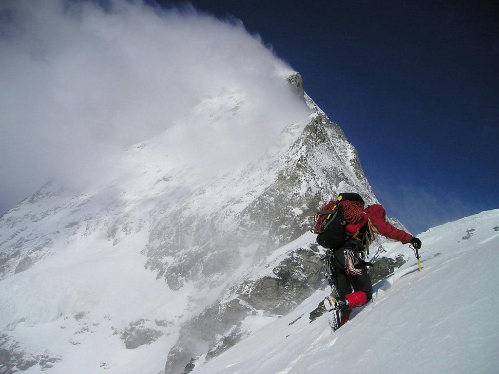 An expert mountain climber on a snowy Alpine peak